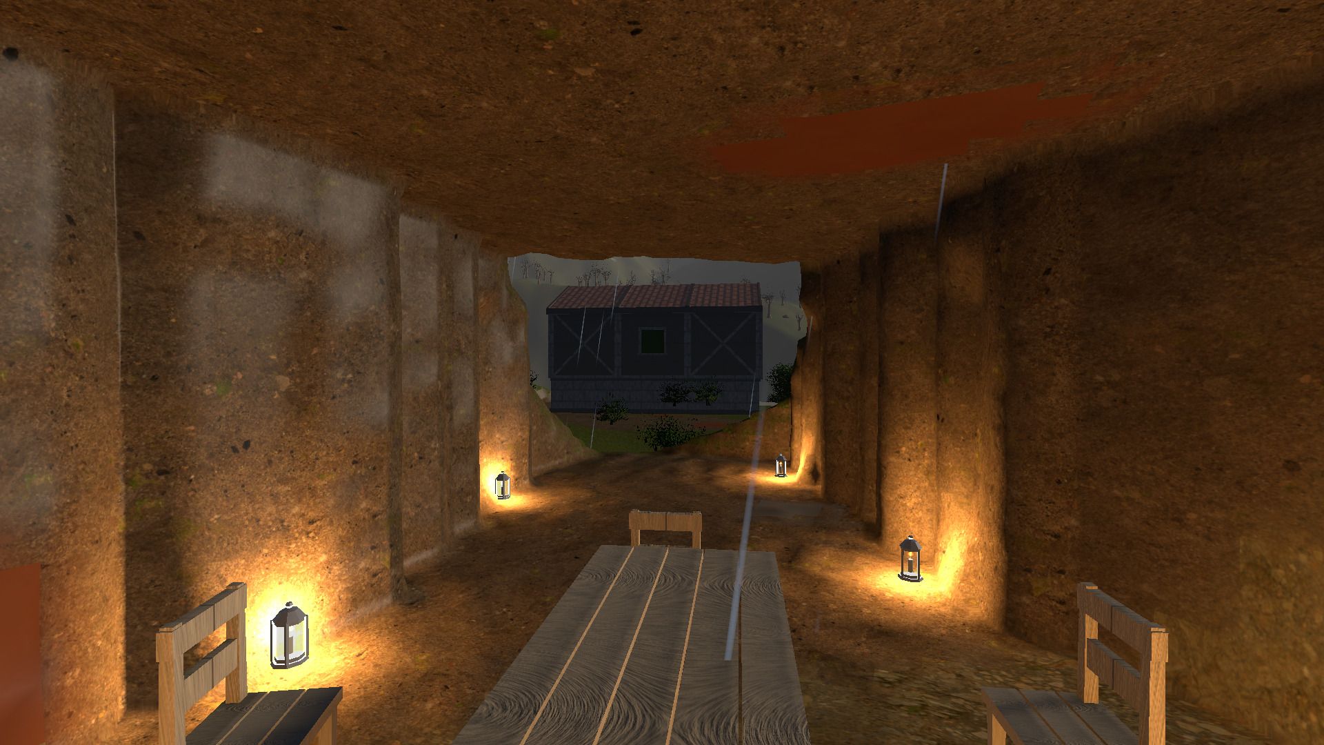 Looking out from inside the lantern-lit tunnel through its mouth to the barn and green hillside outside